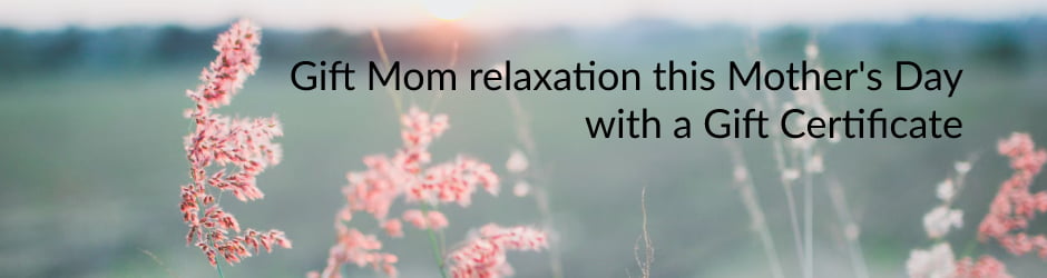 Gift Mom relaxation this Mother's Day with a Gift Certificate - text on background of field with pink flowering grass